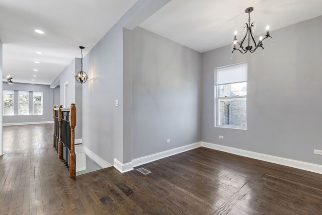 5068 W Congress Pkwy, Chicago, IL 60644 - unfurnished room with a chandelier, dark wood-style flooring, and baseboards