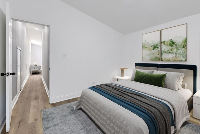5068 W Congress Pkwy, Chicago, IL 60644 - bedroom with wood finished floors, baseboards, and vaulted ceiling