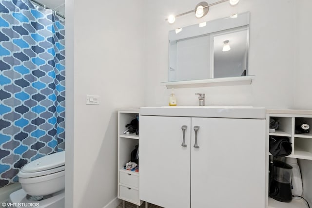 bathroom featuring toilet, baseboards, curtained shower, and vanity
