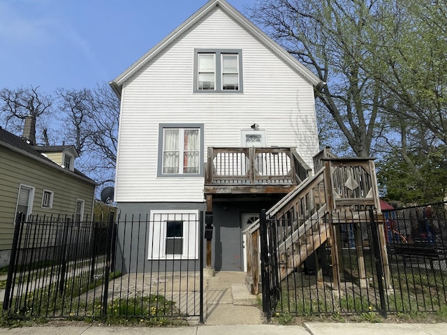 7340 S Maryland Ave, Chicago, IL 60619 - rear view of house with a fenced front yard, a deck, a gate, and stairs