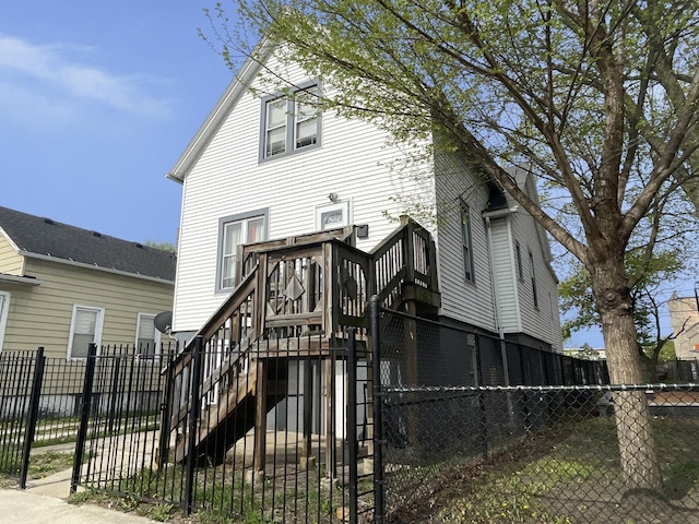 7340 S Maryland Ave, Chicago, IL 60619 - rear view of house with stairway, a fenced front yard, and a gate