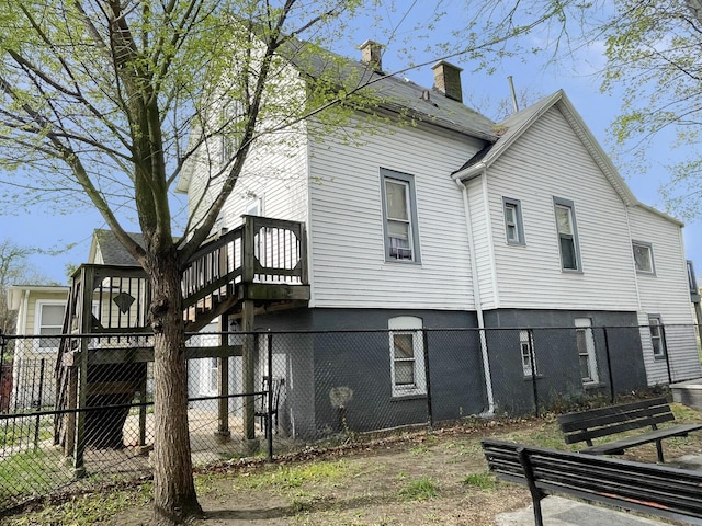 7340 S Maryland Ave, Chicago, IL 60619 - back of property featuring a fenced backyard, a chimney, and a wooden deck