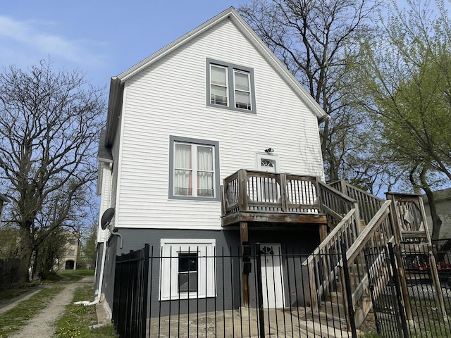 7340 S Maryland Ave, Chicago, IL 60619 - rear view of property with a fenced front yard, a wooden deck, stairway, and a gate