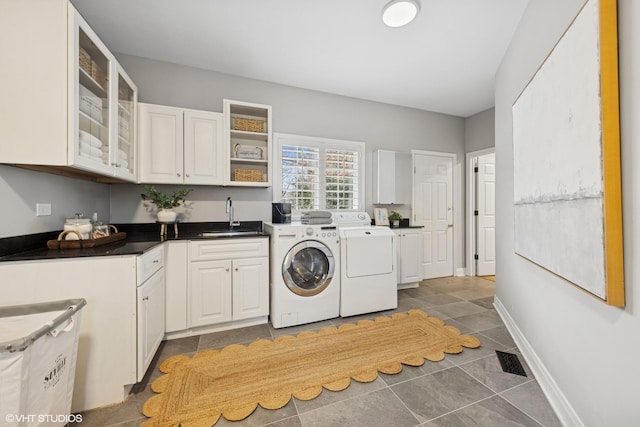 clothes washing area with tile patterned flooring, visible vents, washer and clothes dryer, a sink, and cabinet space