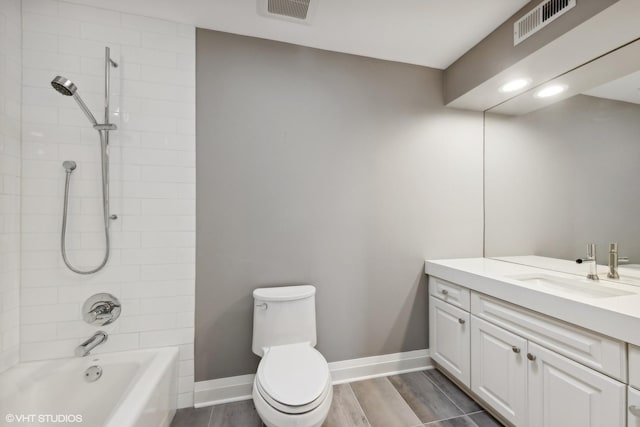 bathroom featuring vanity, toilet,  shower combination, and visible vents
