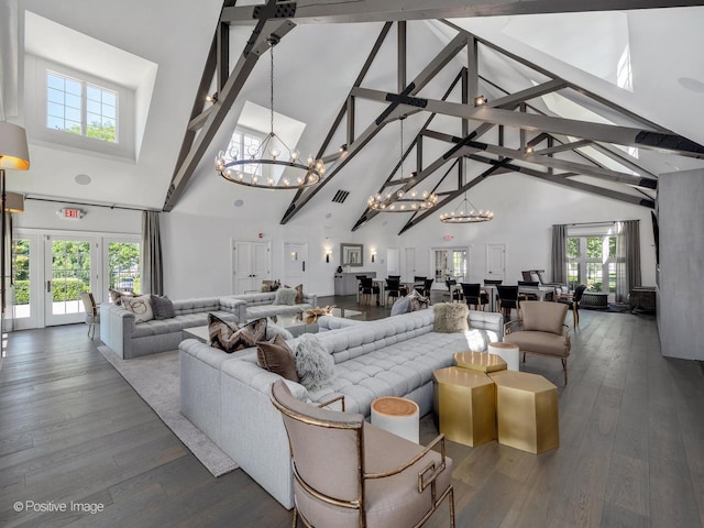 living room featuring visible vents, a notable chandelier, high vaulted ceiling, and hardwood / wood-style flooring