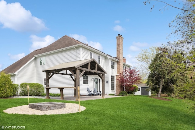 26W241 Arrow Glen Ct, Wheaton, IL 60189 - back of property featuring a chimney, a gazebo, a fire pit, a lawn, and a patio