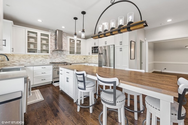 26W241 Arrow Glen Ct, Wheaton, IL 60189 - kitchen with appliances with stainless steel finishes, wall chimney exhaust hood, a sink, tasteful backsplash, and dark wood-style flooring