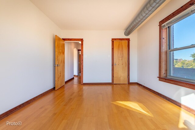 unfurnished room featuring baseboards and wood finished floors