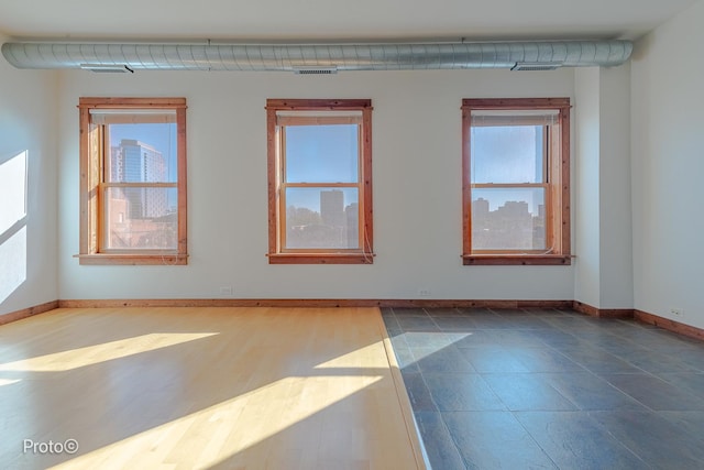 spare room featuring visible vents and baseboards