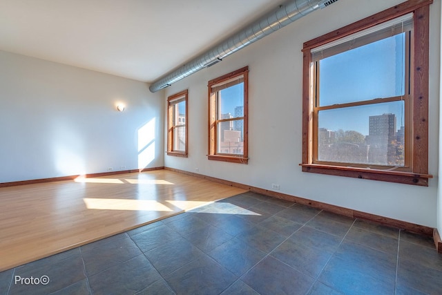 unfurnished room featuring baseboards