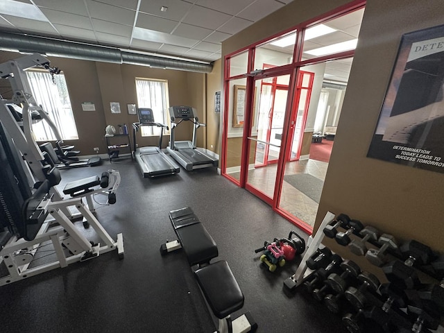 exercise room with a paneled ceiling
