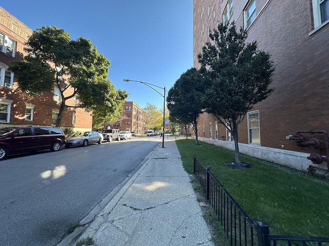 view of road featuring street lighting, curbs, and sidewalks