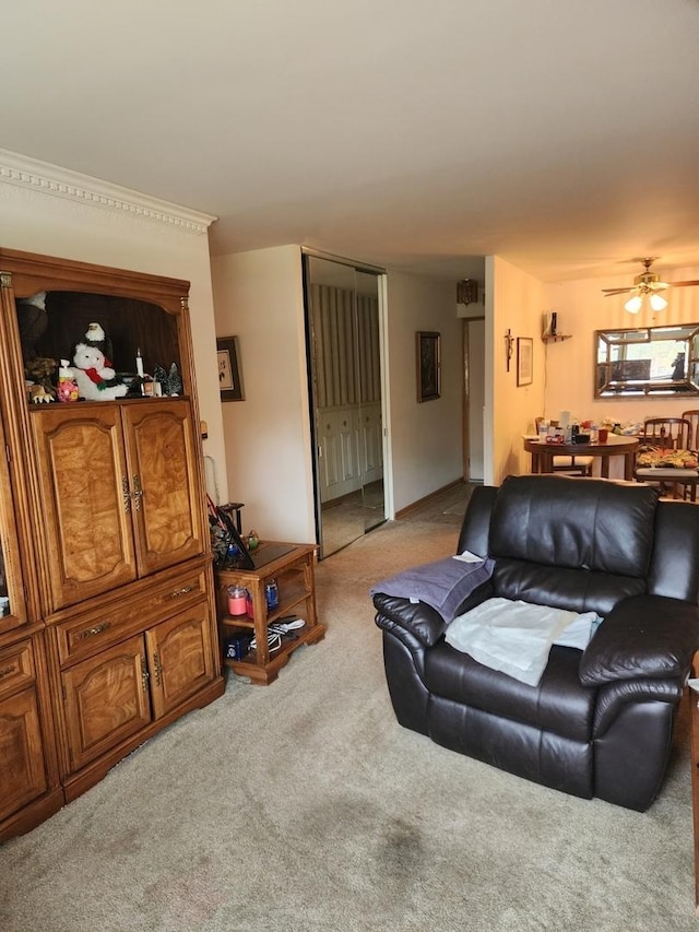 living area with carpet and a ceiling fan