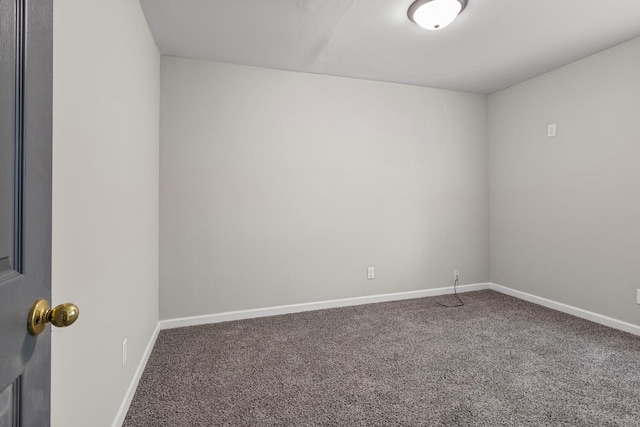 carpeted spare room with baseboards