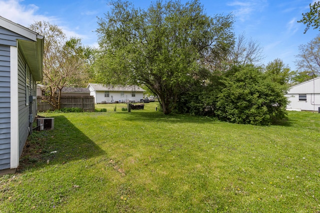 view of yard featuring fence and cooling unit