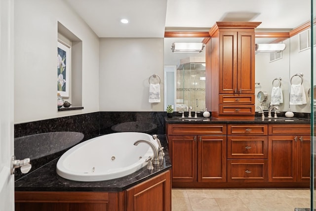 full bath featuring double vanity, a whirlpool tub, a shower stall, and a sink