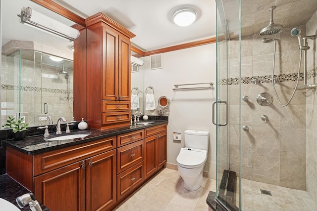 bathroom featuring a sink, a stall shower, toilet, and visible vents