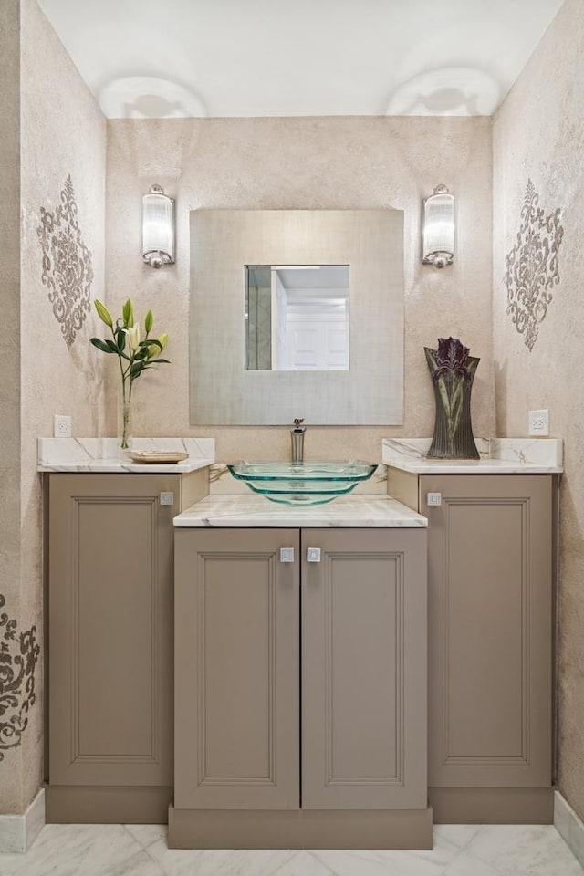 bathroom with marble finish floor and vanity