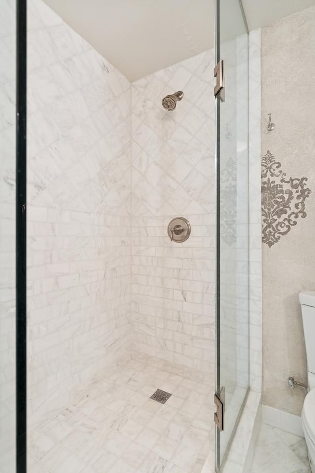 full bathroom with toilet and a shower stall