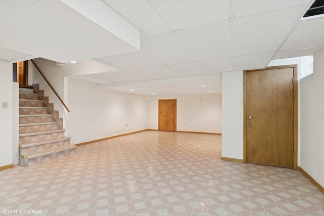 515 S Inner Circle Dr, Mount Prospect, IL 60056 - finished below grade area with baseboards, a paneled ceiling, tile patterned floors, and stairway