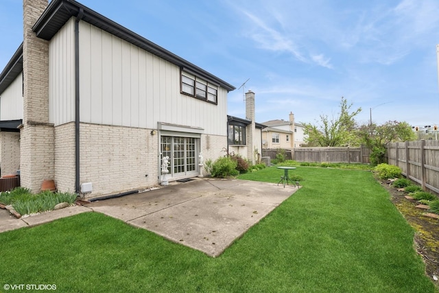 515 S Inner Circle Dr, Mount Prospect, IL 60056 - rear view of property with a patio, a fenced backyard, a chimney, and brick siding