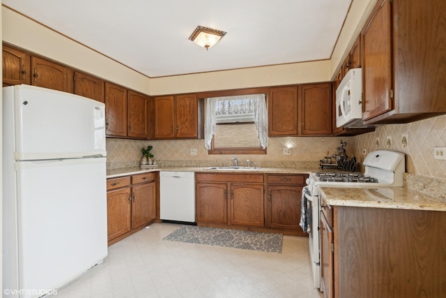 515 S Inner Circle Dr, Mount Prospect, IL 60056 - kitchen with brown cabinetry, decorative backsplash, white appliances, light floors, and a sink