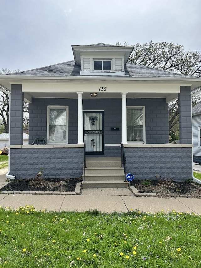 bungalow-style house featuring a shingled roof and a porch