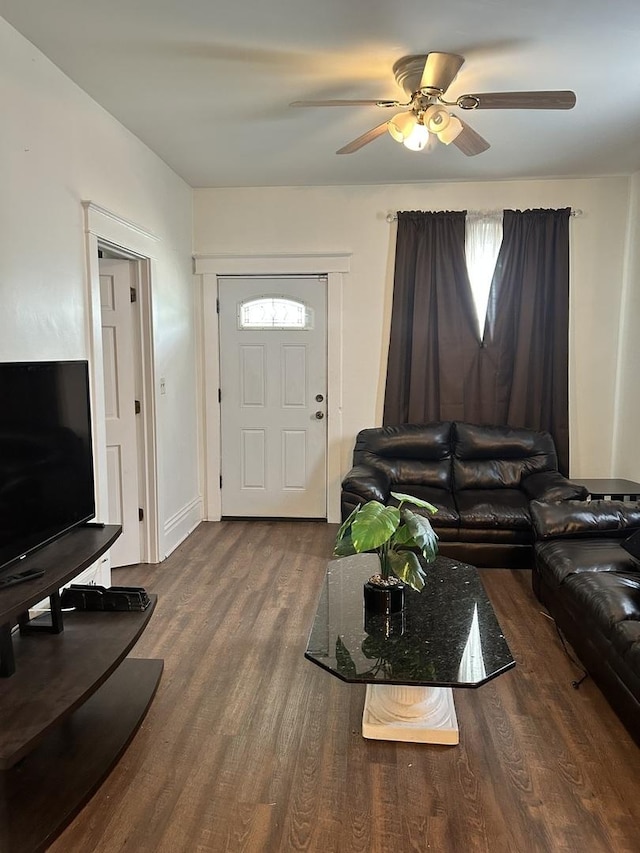 living room featuring a ceiling fan and wood finished floors
