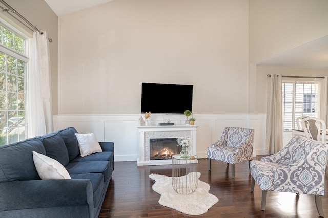 553 Ivory Ln, Bartlett, IL 60103 - living area with dark wood-style flooring, a decorative wall, a wainscoted wall, and a lit fireplace