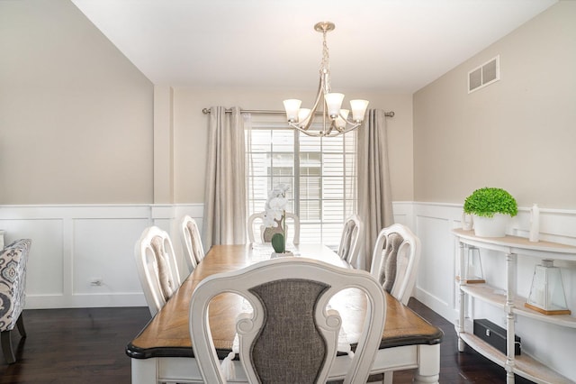553 Ivory Ln, Bartlett, IL 60103 - dining space with visible vents, dark wood-style flooring, a decorative wall, and an inviting chandelier