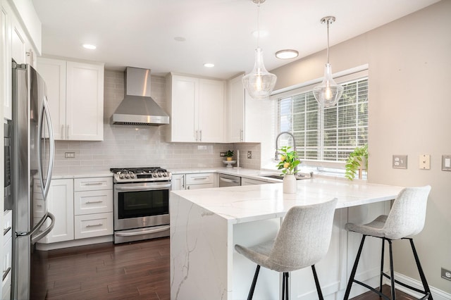 553 Ivory Ln, Bartlett, IL 60103 - kitchen featuring backsplash, appliances with stainless steel finishes, a peninsula, dark wood-style floors, and wall chimney exhaust hood