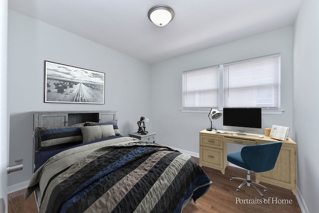 bedroom with baseboards and wood finished floors