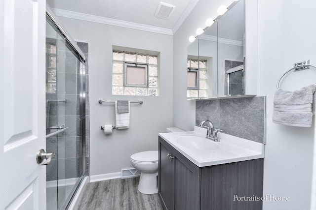full bath featuring vanity, visible vents, wood finished floors, and a stall shower