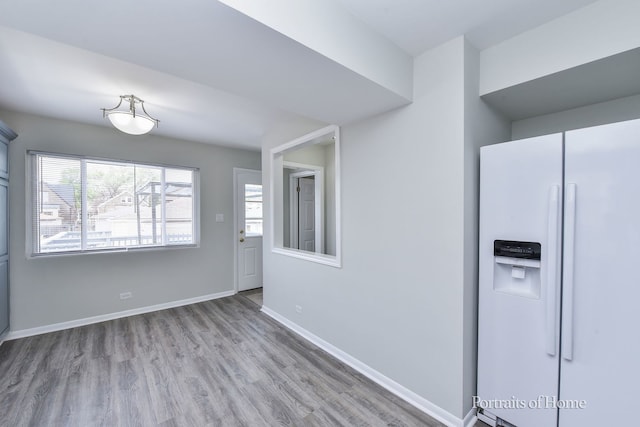 interior space with baseboards and wood finished floors