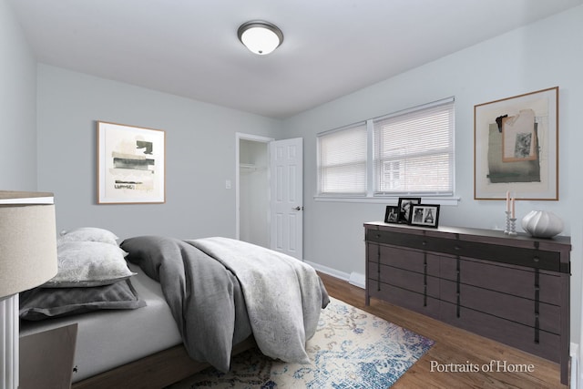 bedroom with baseboards and wood finished floors