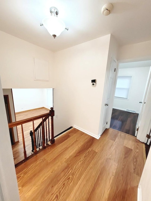 957 Harvard Ln, Matteson, IL 60443 - corridor with baseboards, visible vents, an upstairs landing, and light wood-type flooring
