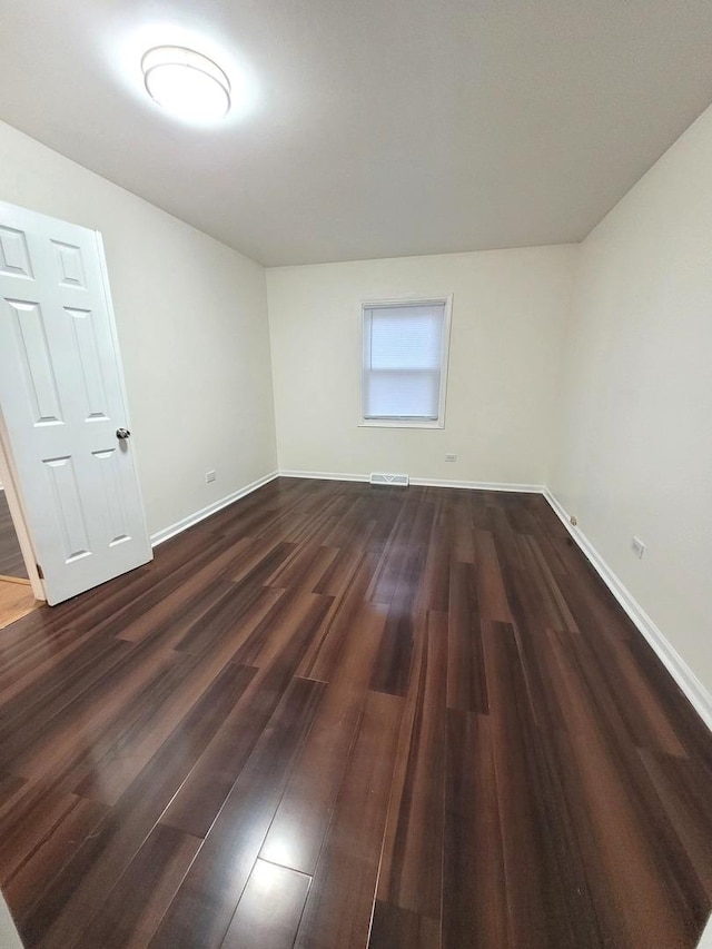 957 Harvard Ln, Matteson, IL 60443 - spare room featuring dark wood-style flooring, baseboards, and visible vents
