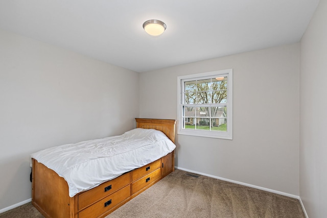 bedroom with visible vents, carpet flooring, and baseboards