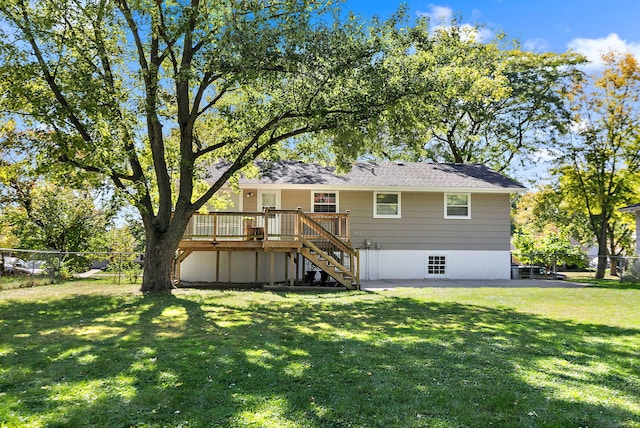 back of house featuring fence, a yard, stairway, and a deck