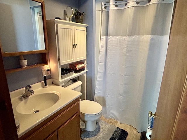 bathroom with toilet, a shower with shower curtain, and vanity