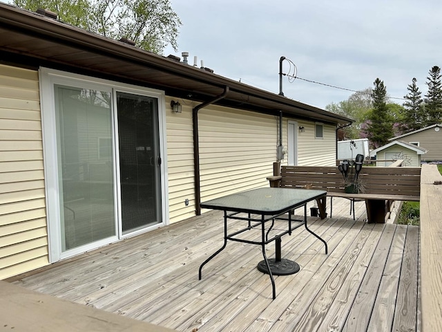 wooden terrace with outdoor dining area