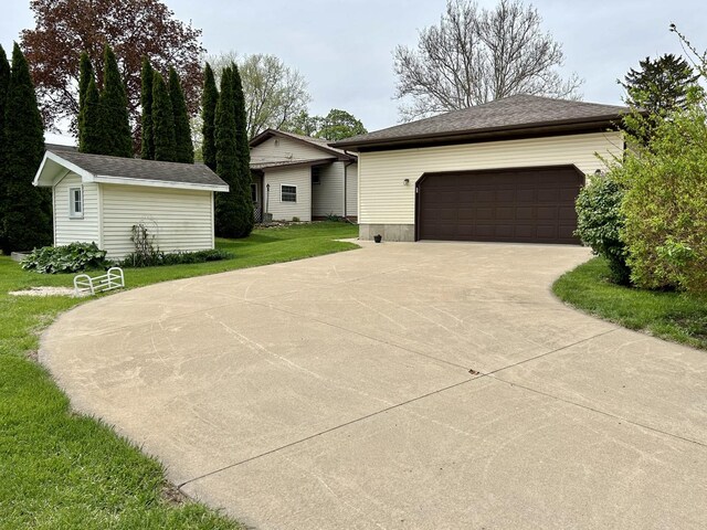 ranch-style home featuring an outbuilding and a front yard