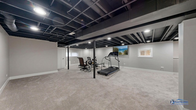 exercise room with baseboards and carpet flooring