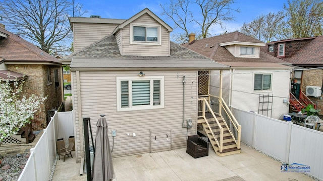 back of house featuring roof with shingles, ac unit, a fenced backyard, and a patio area