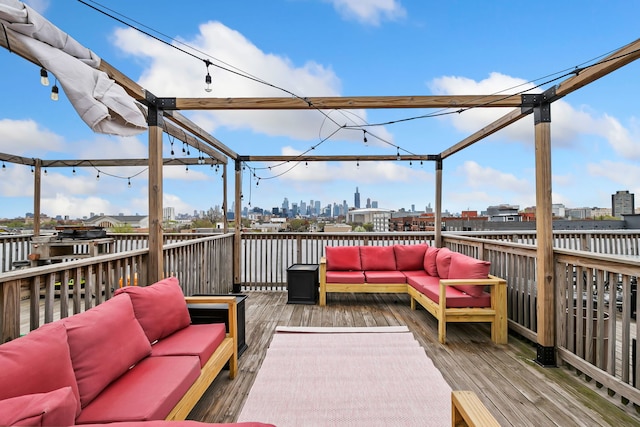 wooden terrace featuring outdoor lounge area and a city view