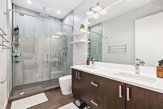 full bathroom featuring a sink, a stall shower, and toilet