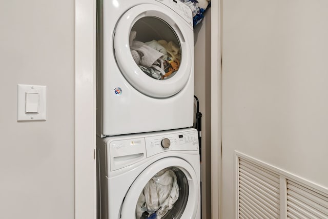 washroom featuring stacked washer and dryer