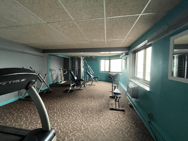 gym with carpet flooring, baseboards, and a drop ceiling