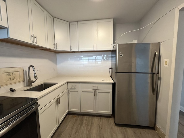 7337 S S Shore Dr Unit 1024, Chicago, IL 60649 - kitchen with freestanding refrigerator, black / electric stove, a sink, wood finished floors, and tasteful backsplash